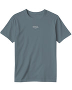 ArvoCulture marka, oversize kesim, gri renkte, pamuklu, bisiklet yaka, kısa kollu, göğüs kısmında minimalist 'STILL RITUALS' baskılı tişört.