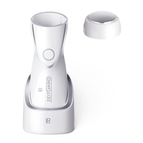 ArvoCulture LR ZEITGARD Pro white facial cleansing device with anti-aging attachment and charging base.